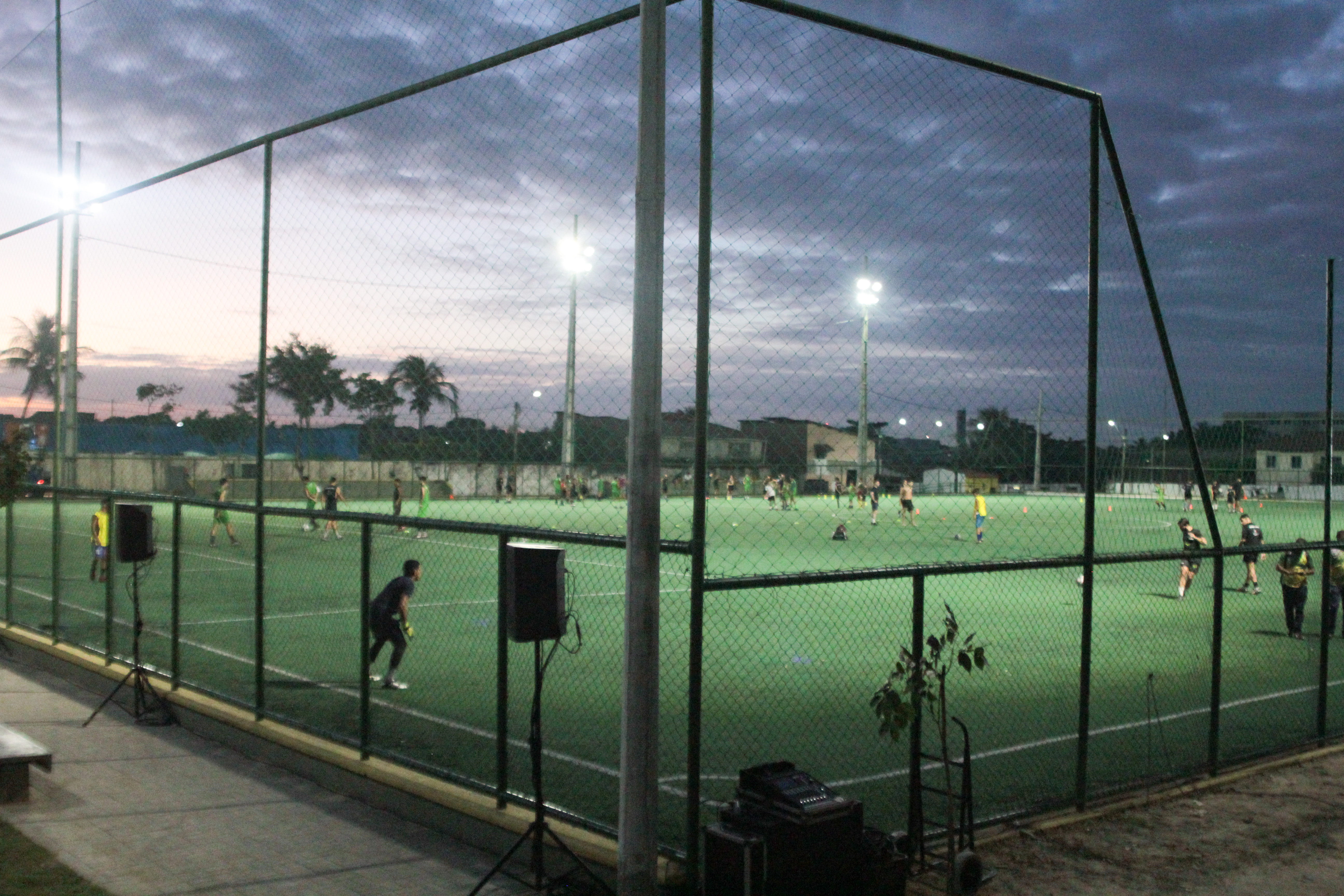 pessoas jogando futebol numa areninha